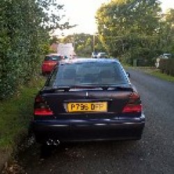 New rear bumper and spoiler with brake light I had to cut out more for the tail pipes.