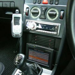 After market Ericsson hands free, Panasonic sat nav, Alpine HU and retro fitted CD holder.