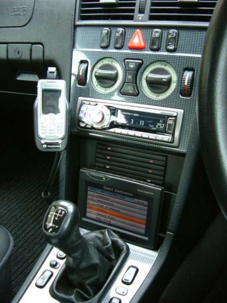 After market Ericsson hands free, Panasonic sat nav, Alpine HU and retro fitted CD holder.